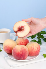Fresh Shandong Peaches from Mengyin Province China - Golden Red Autumn Fruit Hand Holding Cut Peach on White Plate