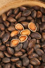 Fresh Pine Nuts Harvested from Yunnan Mountains in Traditional Wooden Bowl