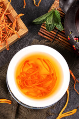 Traditional Chinese Cordyceps Herbal Medicine Tea with Golden Color and Tea Ceremony Accessories