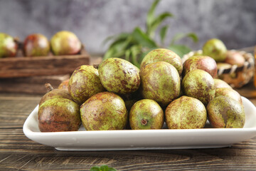 Fresh Camellia Seeds on Plate - Natural Eco-Friendly Harvest for Oil Production