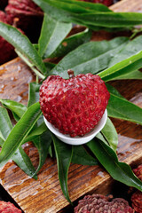 Fresh Ripe Lychee Fruit on Green Leaves and Wooden Background - Tropical Exotic Fruit Display