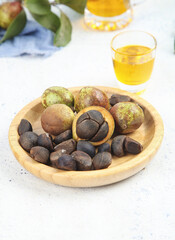 Camellia Tea Seeds with Golden Oil in Wooden Bowl - Natural Harvest Organic Ingredients