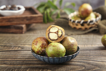 Camellia Tea Oil Seeds in Bowl on Wooden Table - Natural Agricultural Harvest Product