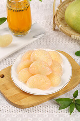 Fresh Pomelo Fruit Segments on Plate with Herbal Tea and Whole Citrus in Basket