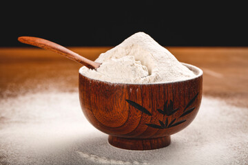 Fresh White Flour in Wooden Bowl with Spoon for Baking and Cooking