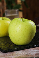 Fresh Sweet Green Apples from Xinjiang on Slate Surface with Water Droplets