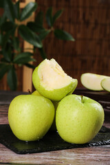 Fresh Wanglin Apples from Dalian Xinjiang - Sweet Imported Freckled Green Fruit on Rustic Wooden Table