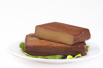 Chinese Dried Bean Curd Tofu Blocks on Plate with Lettuce Leaves Traditional Asian Food Ingredient