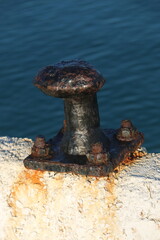 rusty bollard on the concrete pier