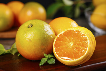 Fresh Summer Oranges with Juicy Sweet Flesh and Thin Skin on Wooden Table