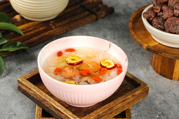Sweet Chinese Soup with Dates Lychee Pork and Red Fungus in Pink Bowl
