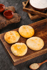 Traditional Five Kernel Mooncakes on Wooden Board for Mid-Autumn Festival Celebration with Tea