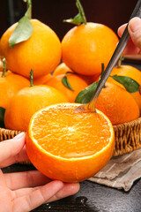 Fresh Orange Fruit Being Cut with Spoon - Citrus Preparation and Healthy Eating