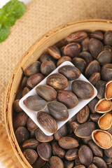 Freshly Harvested Wild Pine Nuts from Deep Mountain Forests in Rustic Wooden Basket with Natural Textures