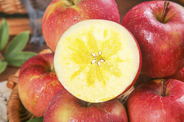 Fresh Red Fuji Apples from Xinjiang China Cut in Half Showing Interior Flesh and Seeds in Wicker Basket