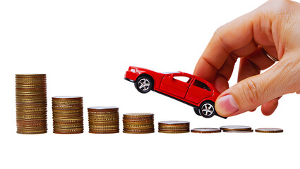 Hand holding red toy car above decreasing stack of coins symbolizing car payment financial planning and cost isolated on transparent background