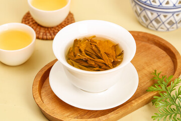 Xinyang Mao Jian Mountain Tea Leaves Brewed in Traditional Chinese Tea Ceremony Setup with White Porcelain Cup