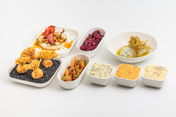 Assorted appetizers with dips, spreads, and vegetables on table