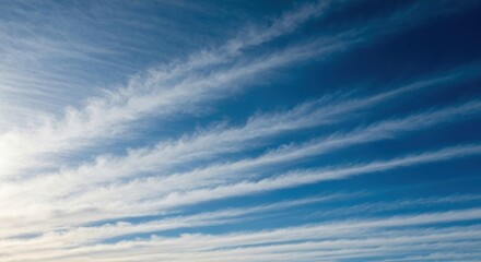 Wispy, streaky clouds against a deep blue sky