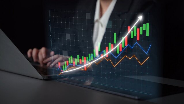 A business professional focuses on analyzing a digital stock market graph on a laptop, showcasing financial data and an upward growth trend in a modern office environment. Copula - Powered by Adobe