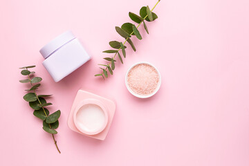 Two unbranded cosmetic containers with hair mask or cream or balm on light pink background with...