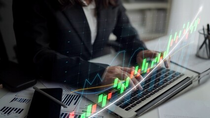 A business professional reviews financial data on a laptop while a stock market graph overlays the scene, representing growth and investment in a modern office environment. Copula