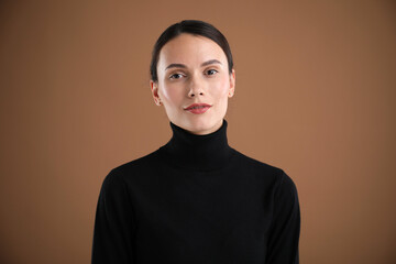 Fototapeta premium Portrait of beautiful woman on brown background