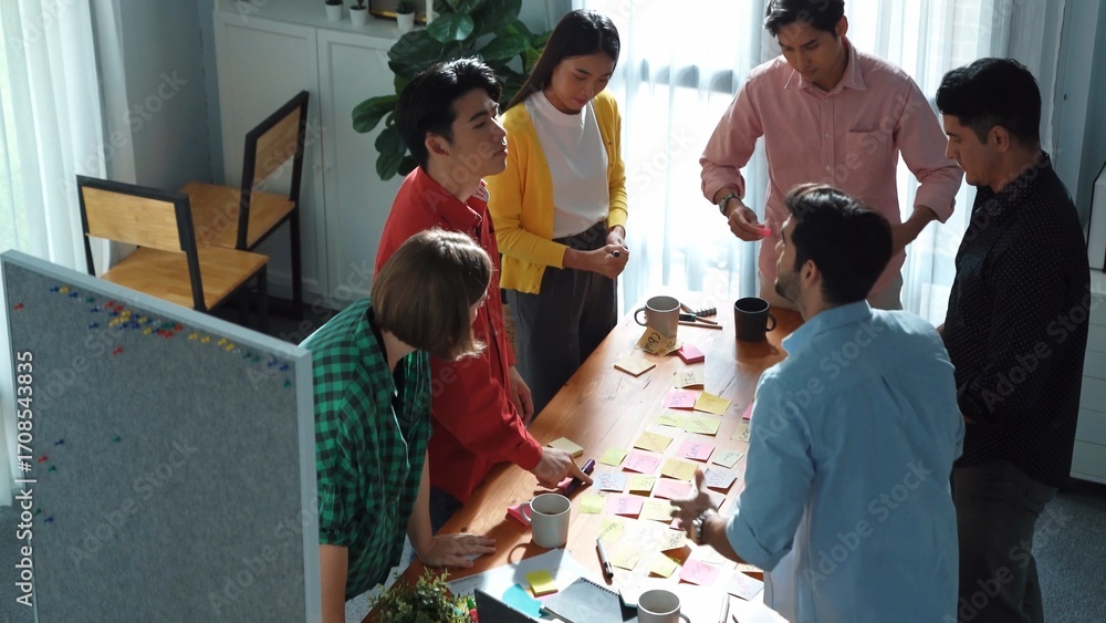Aufkleber top view of smart business team writing marketing idea on colorful sticky notes while start up team 