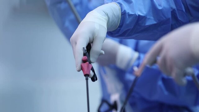A close-up view of a surgeon's gloved hands performing a nasal endoscopy. Medical instruments are used to examine the nasal passages during the minimally invasive procedure.