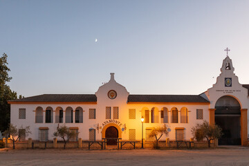 El Rocio, Sevilla, Andalusia, Spain. 28 August 2025. Hermandad house illuminated at dusk