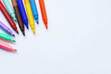 Colorful markers arranged in a semi-circle on a white background