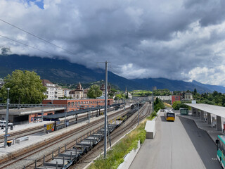 Overview of Sierre railway station in Valais, Switzerland, taken from an elevated position during summer.