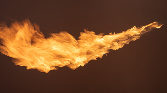 stream of fiery flame isolated on a black background