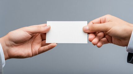 A white card is being passed between two people