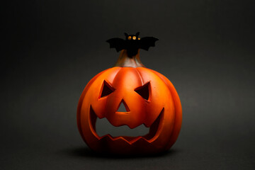 Halloween jack-o-lantern with bat and spider creating eerie decoration symbolizing mystery, darkness, and spooky festive atmosphere