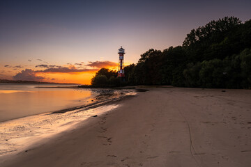 A great lighthouse at sunset on the Elbe in Hamburg.