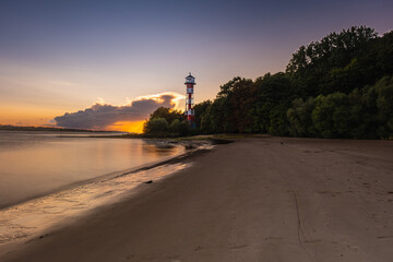 A great lighthouse at sunset on the Elbe in Hamburg.