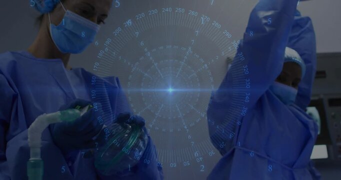 Medical surgeon adjusting IV, donning gloves, assistant placing anesthesia mask preparing sedation
