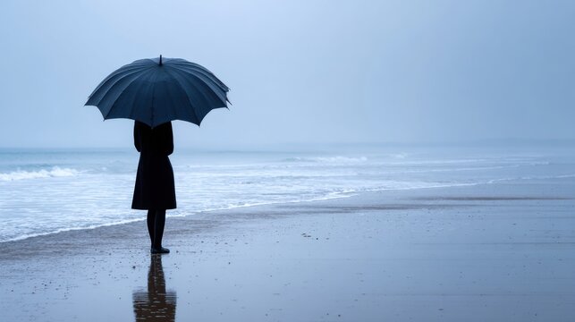 Silhouette with open umbrella in heavy rain on the beach, emotional resilience and quiet strength metaphor