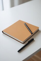 Notebook and pen placed on table for writing or note taking