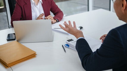 Attorney consulting clients in law firm office with professional discussion
