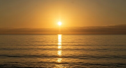 Obraz premium Golden sunrise over calm ocean