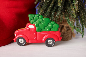 Saint Nicholas day. Tasty cookie in shape of car, fir tree and red boot on white wooden table, closeup