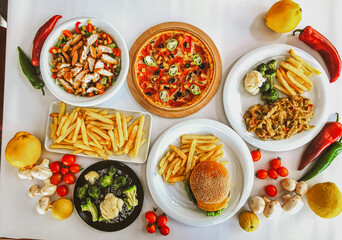 Delicious meat kebab with fresh vegetable salad served with variety of Turkish dishes and appetizers. Top view of assorted Turkish food and meze, tasty and healthy Mediterranean cuisine. Top view.