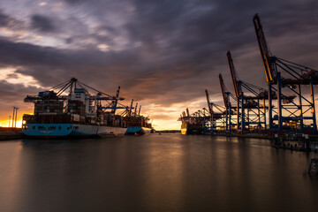 The magnificent Waltershofer Damm container port at sunset with its huge container ships.