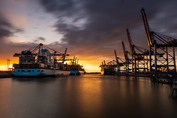The magnificent Waltershofer Damm container port at sunset with its huge container ships.