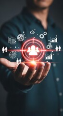 Naklejka premium Hand holding glowing target with people icons and business analytics symbols