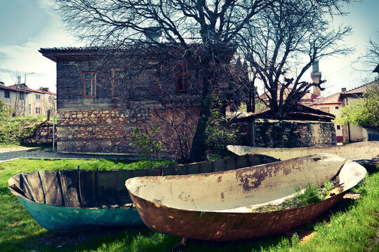 Fishing boats in front of old turkish house. Yesil Ada "Green Island", Egirdir, Isparta Province, Turkey