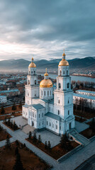 Obraz premium Golden Domes: A breathtaking aerial shot of a grand building with shimmering gold domes and elegant architecture, nestled amidst a serene cityscape under a picturesque cloudy sky.