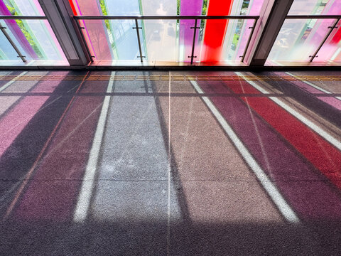 Sunlight casting colorful shadows through tinted glass panels